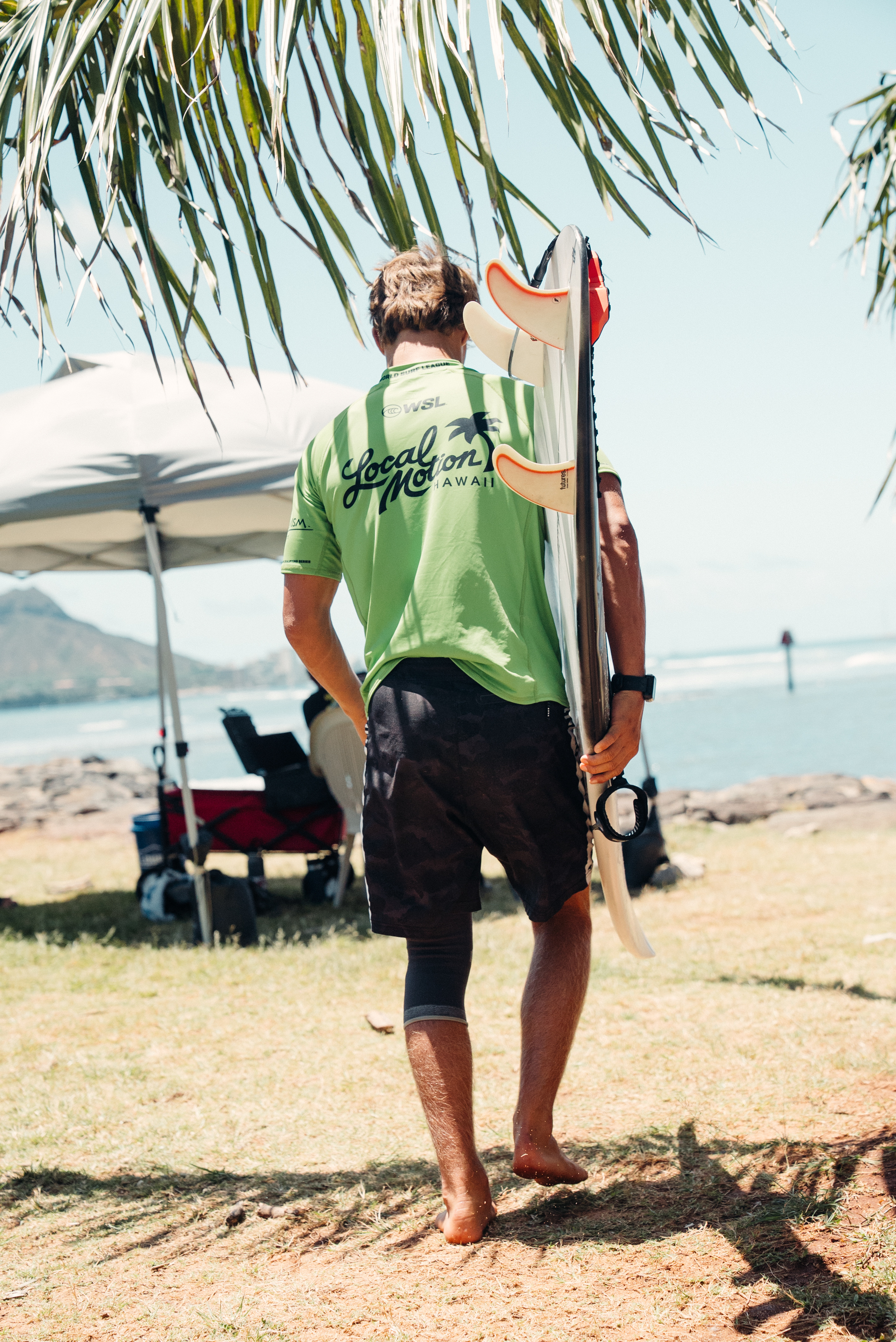 Ezra Clark on the rocks with Diamond Head in the distance