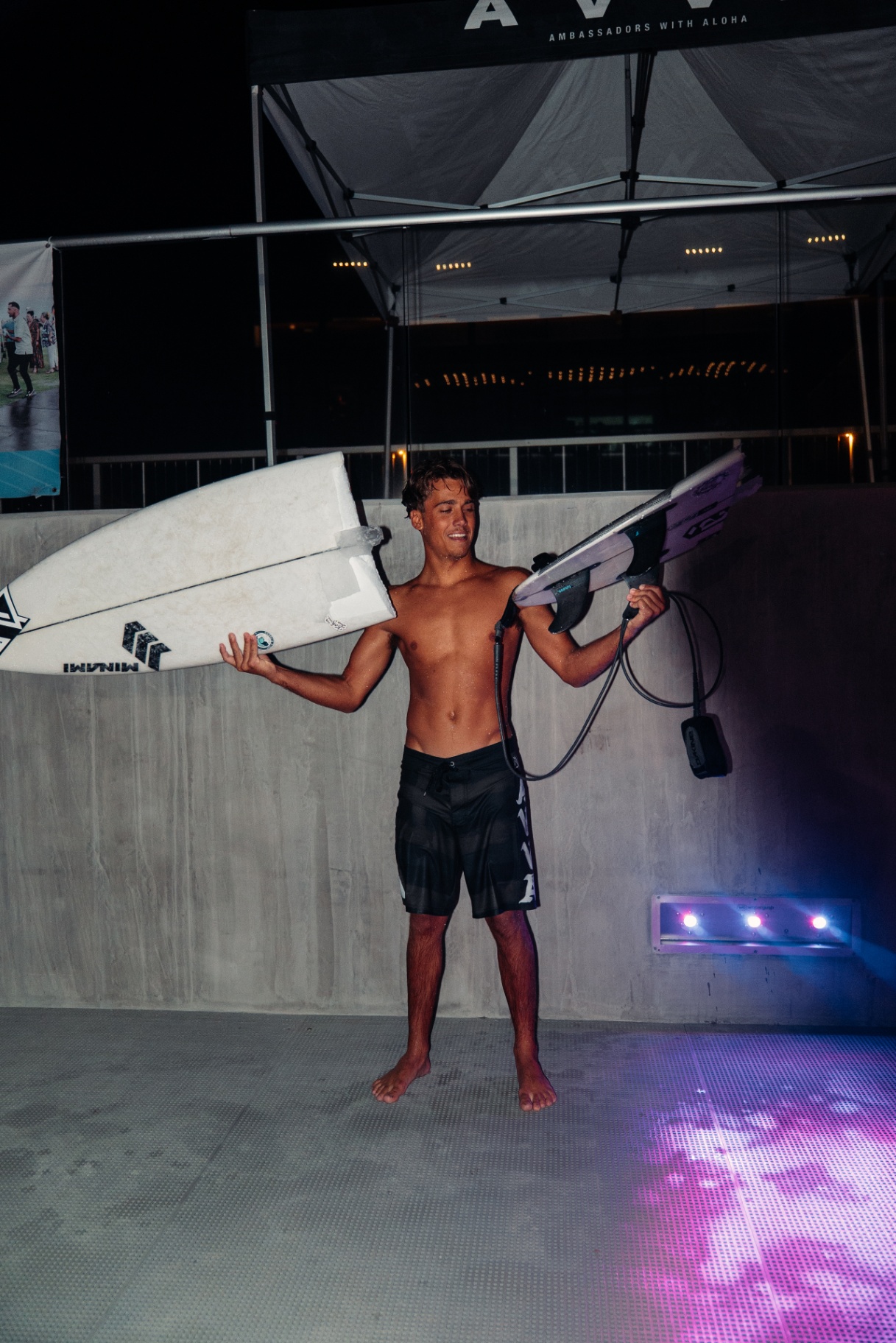 AVVA rider carrying two boards under the tent