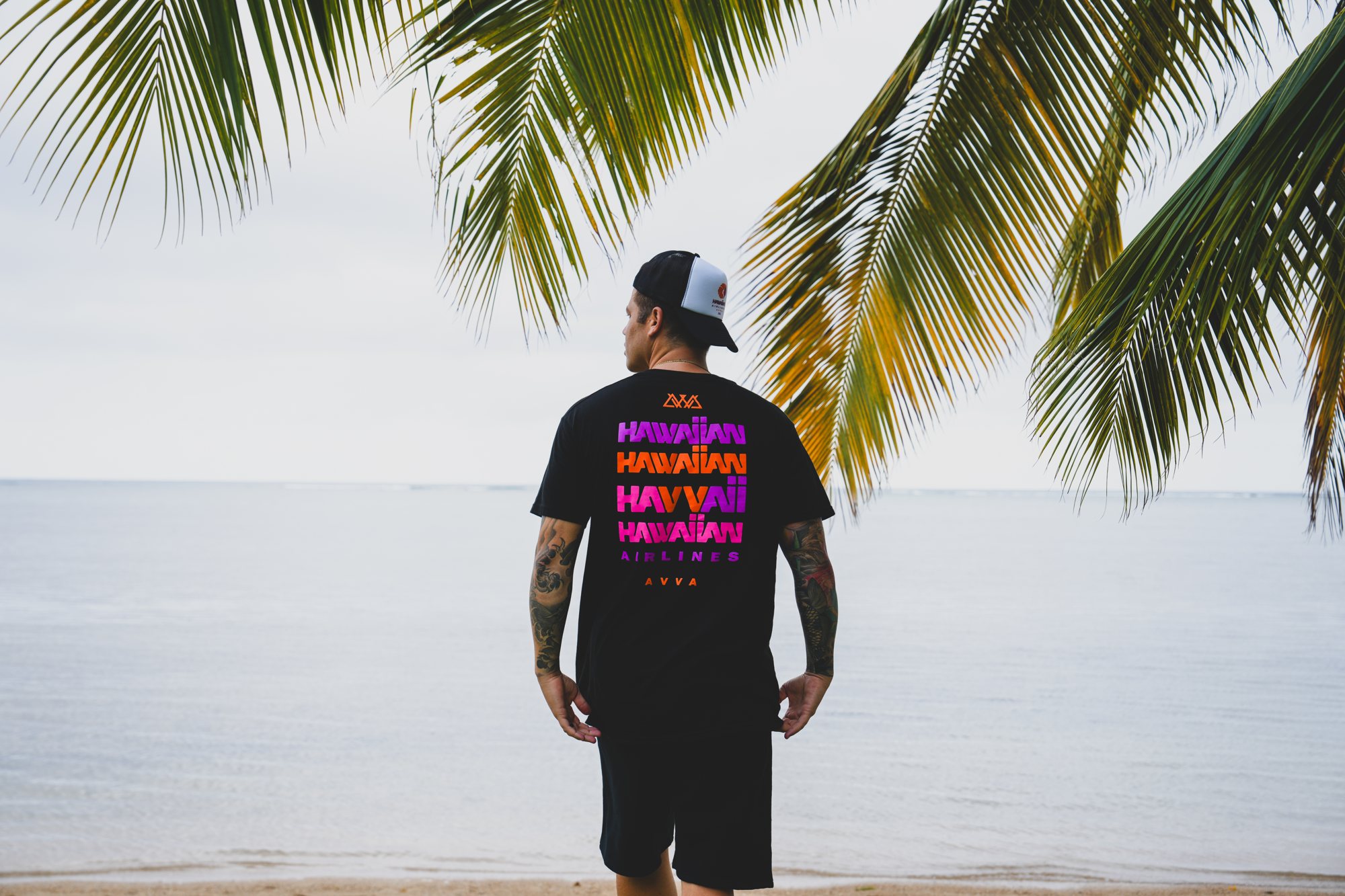 AVVA × Hawaiian Airlines — black tee on the shoreline