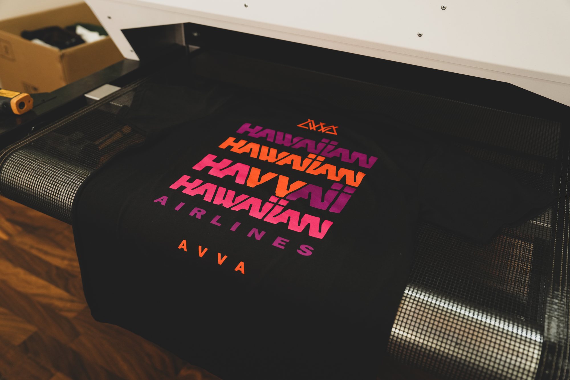Hawaiian Airlines × AVVA tee on the screen printing press