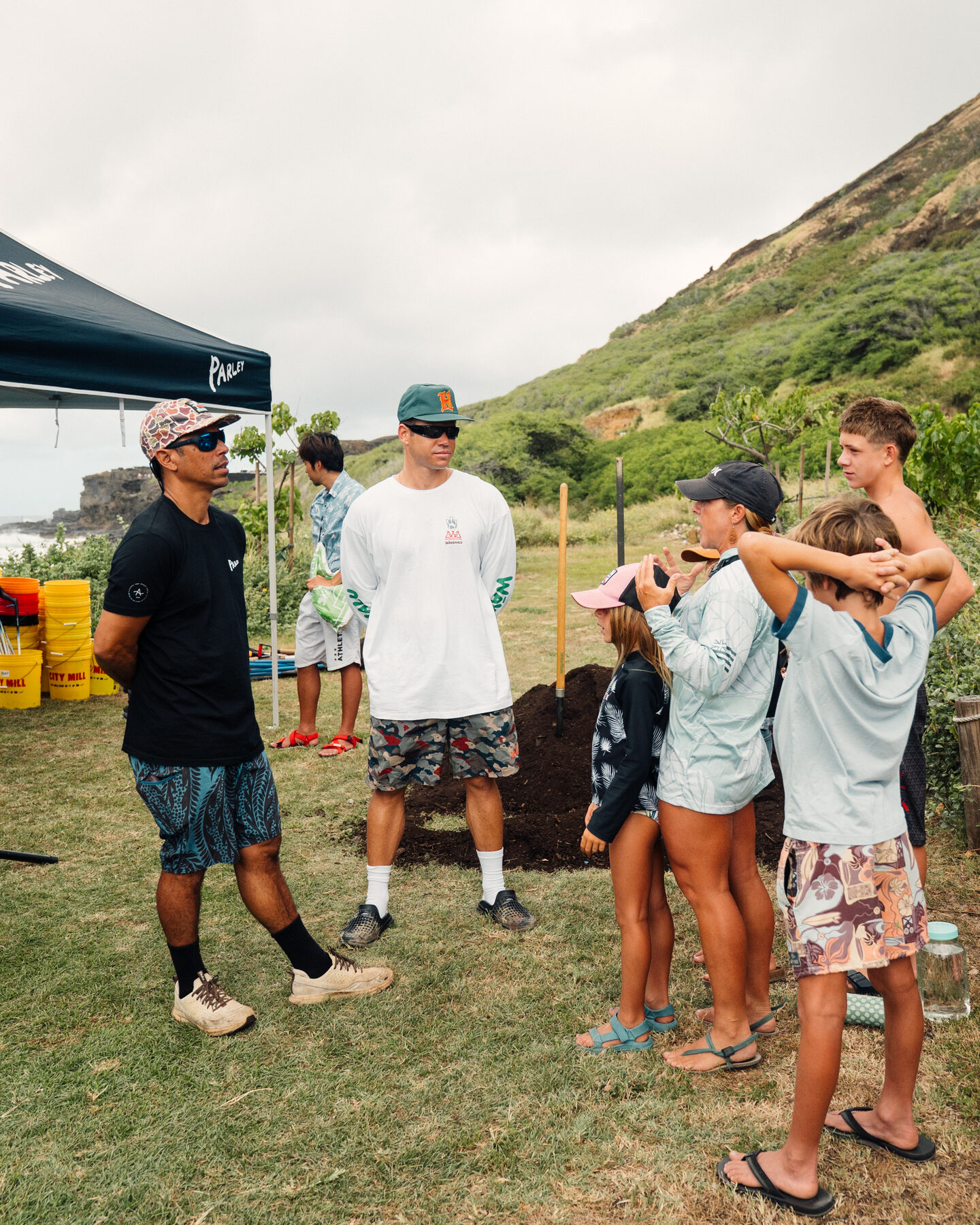 Volunteers gather under the tent before the cleanup