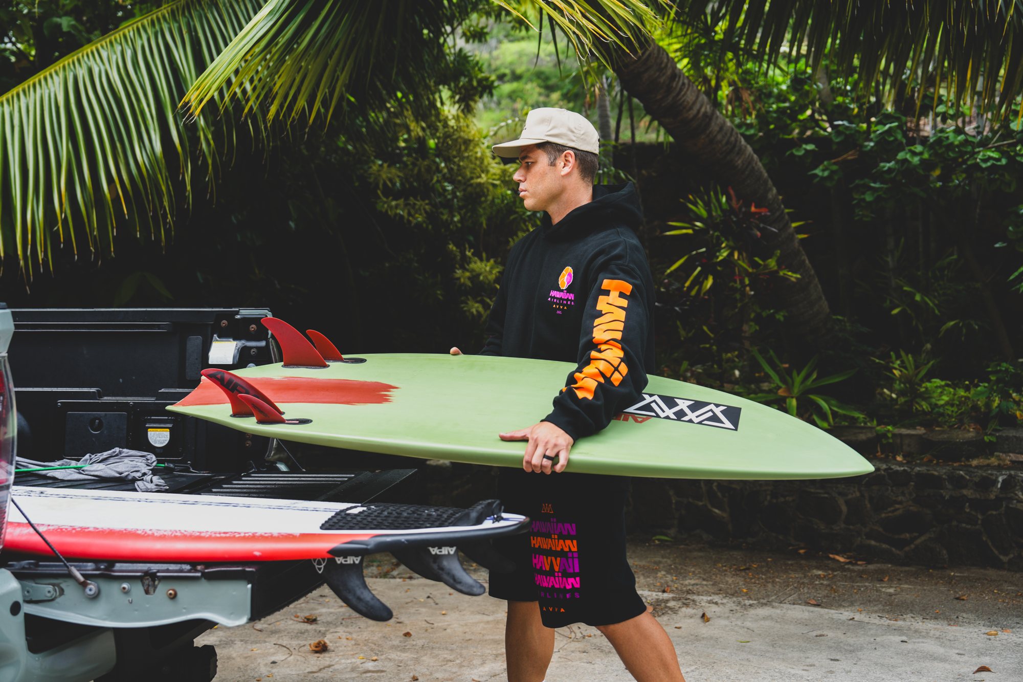 Hawaiian Airlines and AVVA collection with a surfboard