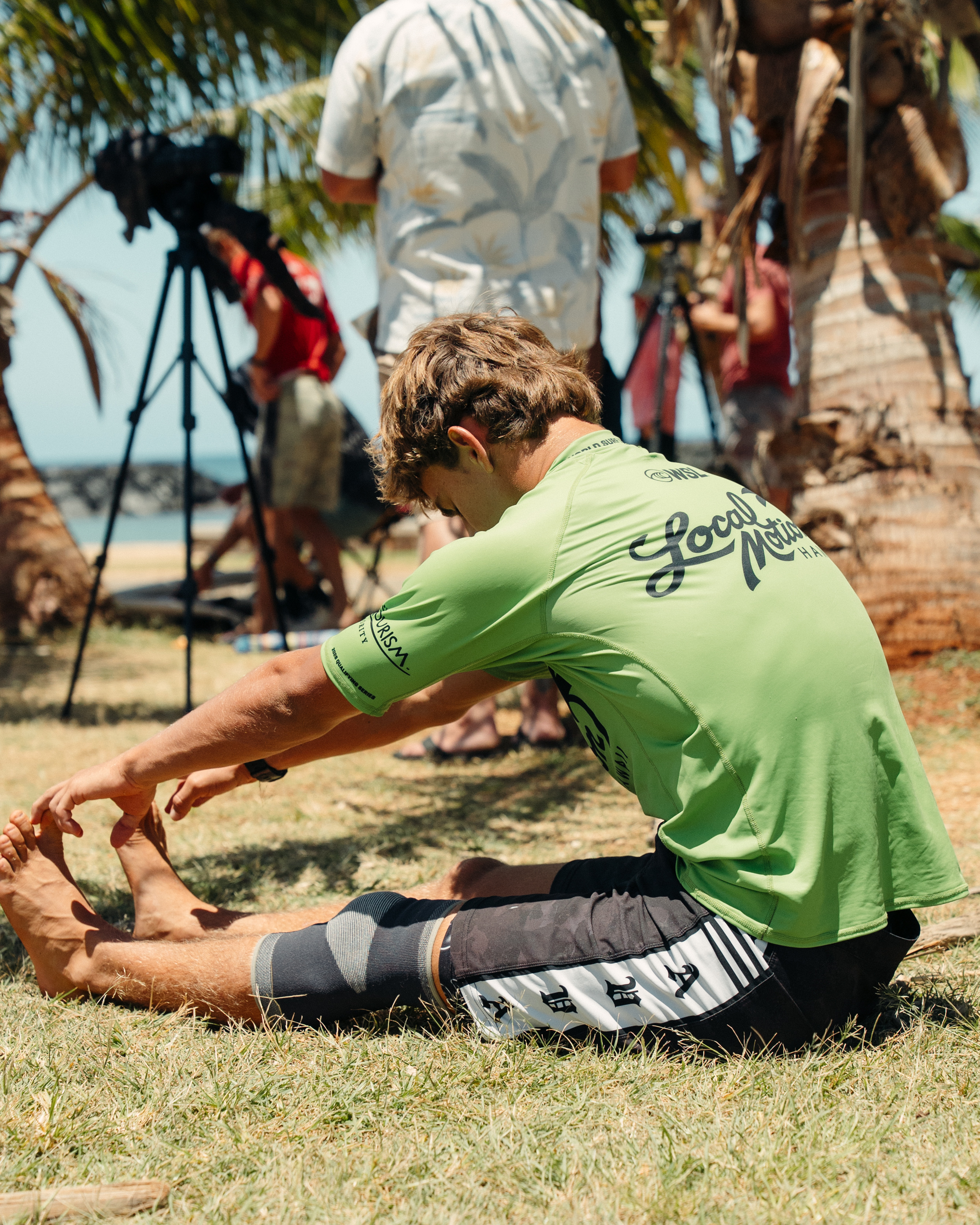 Ezra Clark stretching in the shade before a heat