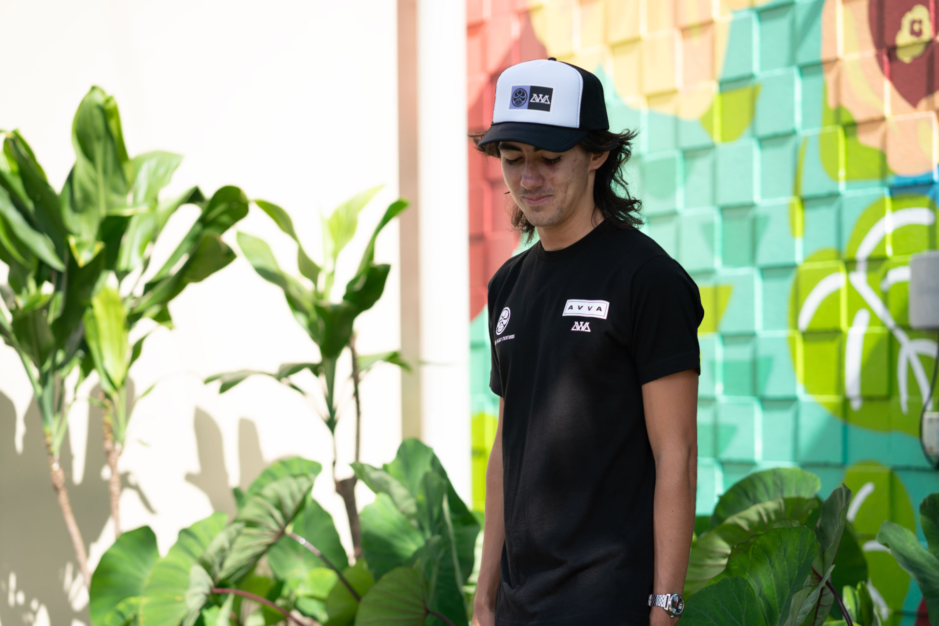 Matt in the black AVVA x HIC tee and collab trucker hat