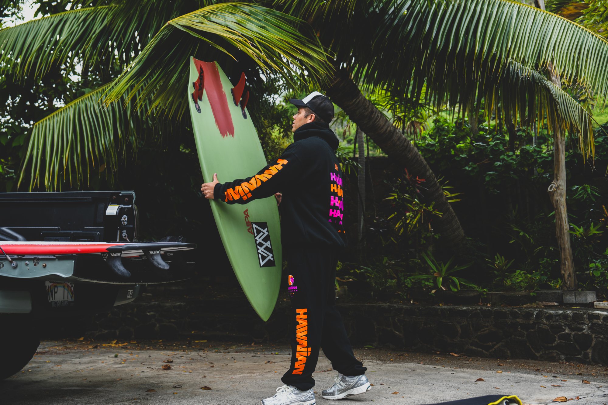 Hawaiian Airlines × AVVA hoodie and shorts, board in hand