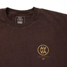 FRONT CLOSE UP VIEW OF BROWN HEAVYWEIGHT CREED TEE. HIGHLIGHTS THE SMALL AVVA LOGO IN TOP RIGHT.
