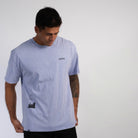 FRONT VIEW OF ISLAND HAZE TEE ON MODEL LOOKING DOWN READJUSTING SHIRT.
