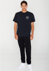 FRONT VIEW OF MODEL WEARING AVVA SKULL BLACK TEE IN STUDIO