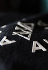 EXTREME CLOSE UP ON FRONT SCREEN PRIINT. CHEST PRINT. RAISED SCREEN PRINT.
