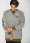 MODEL WEARING ALL NATIONS REVERSIBLE CREW. HIGLIGHTNIG SLEEVE SCREENPRINT. SHOWING THE INSIDE OF THE SWEATSHIRT, PALE GREEN.