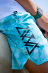 CLOSE UP DETAIL PHOTO OF KOA TRAINING SHORT BLUE CLOUDWASH. AVVA LOGO DOWN LEG.