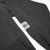 CLOSE UP VIEW OF SLEEVE LOGO SCREEN PRINT OF DISCOVER BLACK PIGMENT FLEECE HOODIE.