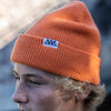 SIDE VIEW OF MODEL WEARING CHASE SUNSET ORANGE BEANIE.