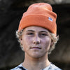 FRONT VIEW OF MODEL WEARING CHASE SUNSET ORANGE BEANIE.