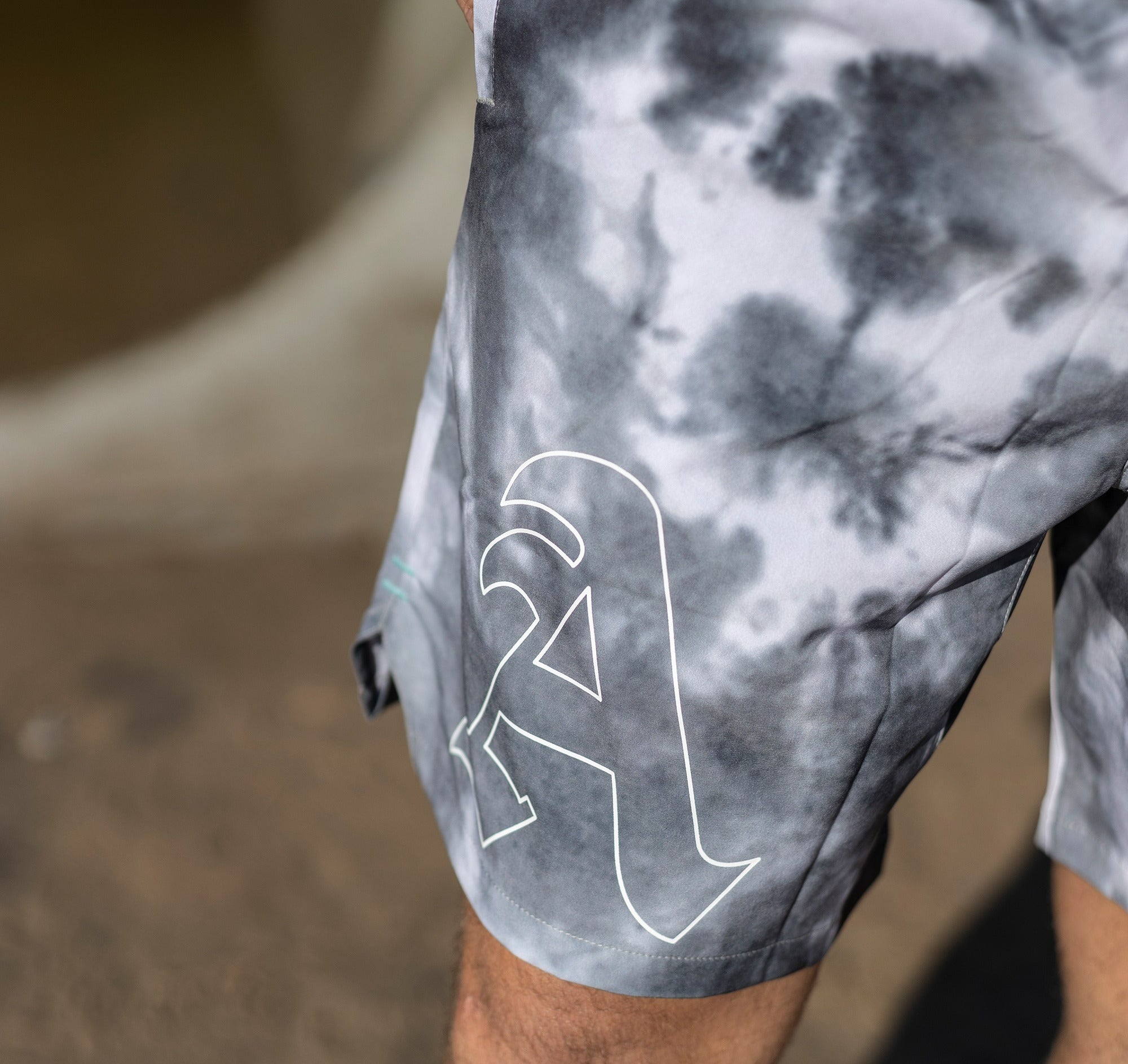 EXTREME FRONT CLOSE UP OF DETAIL PRINT OF SMOKE WATER CLOUD WASH TRAINING SHORTS WORN BY MODEL KEKOA.