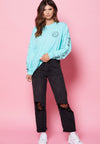 FEMALE MODEL WEARING BEACH STREETS MINT LONG SLEEVE TEE WITH PINK BACKDROP