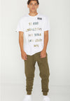 MODEL FACING FORWARD WEARING BE THE AMASSADOR WHITE TEE. IN STUDIO