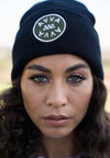 CLOSE UP ON MODEL WEARING THE BERLIN BLACK BEANIE FEATURING FRONT EAMBROIDERY