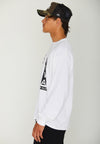 SIDEVIEW OF MODEL WEARING CHAZ MOSAIC WHITE LONG SLEEVE TEE. IN STUDIO.