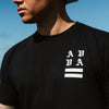 CLOSE UP OF FRONT CHEST ON MODEL WEARING BACK VIEW OF MODEL WEARING CHESTER BLACK TEE FEATURING AVVA LOGO SCREEN PRINT DETAIL