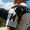 EXTREME BACK AND SLEEVE CLOSE UP OF MODEL WEARING KAIMANA TEE FEATURING SCREEN PRINTING DETAILS