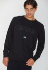 CLOSE UP FRONT VIEW OF MODEL SHOWING THE OUTSIDE OF THE MADISON REVERSIBLE BLACK CREW