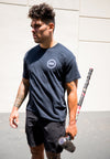 FRONT VIEW OF WORK OUT MODEL WEARING NIXON BLACK TEE