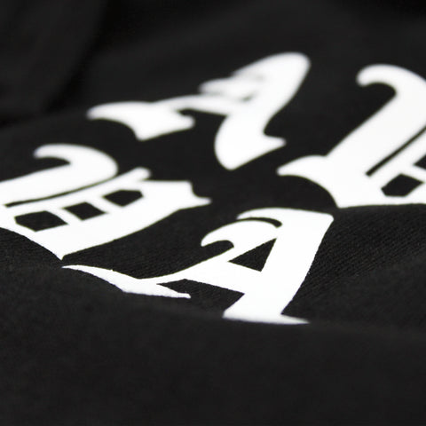 STYLIZED EXTREME CLOSE UP OF SCREEN PRINT DETAIL OF OCEAN SOUL ZIP UP BLACK HOODIE